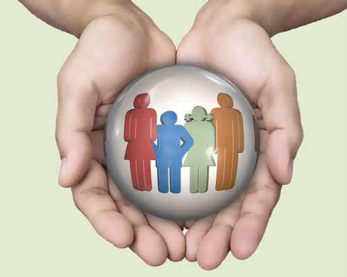 Hands protecting a family